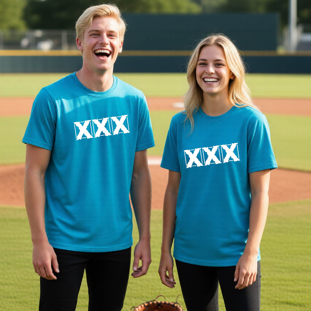 Two teenagers standing on a baseball field wearing matching bright blue short-sleeve shirts with a white letter logo 'XXX' graphic across the chest.