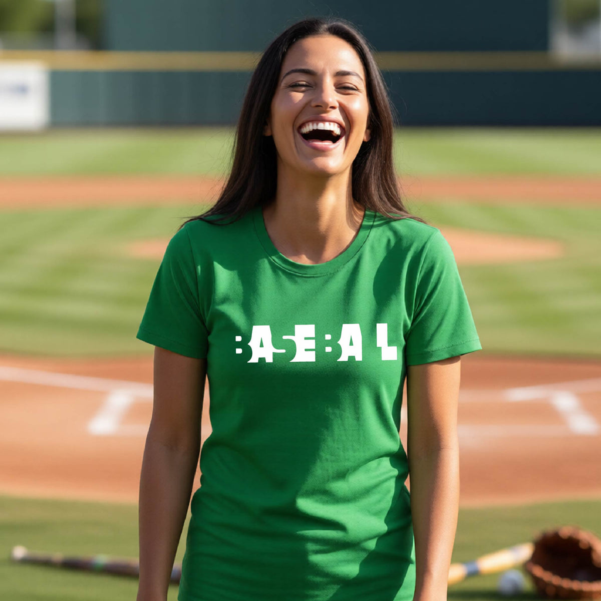 A smiling woman wearing a green short-sleeve athletic shirt with the white text 'BASEBALL' in a cutout design printed across the chest, standing on a baseball field.