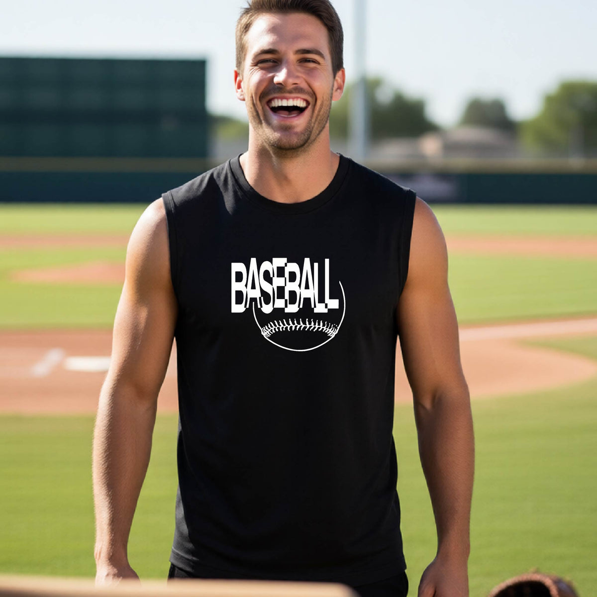 A man laughing on a baseball field wearing a black sleeveless t-shirt with a white 'BASEBALL' graphic and baseball stitching design on the front, standing on a baseball field.
