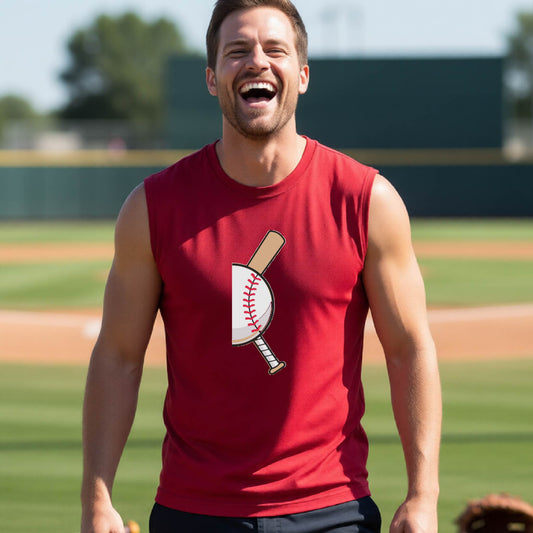 A man smiling in front of a baseball diamond wearing a red sleeveless t-shirt, with a colorful graphic of a half baseball with a curved bat behind it, printed on the front of the shirt. 