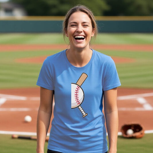 A woman smiling in front of a baseball diamond wearing a blue short-sleeve t-shirt, with a colorful graphic of a half baseball with a curved bat behind it, printed on the front of the shirt. 