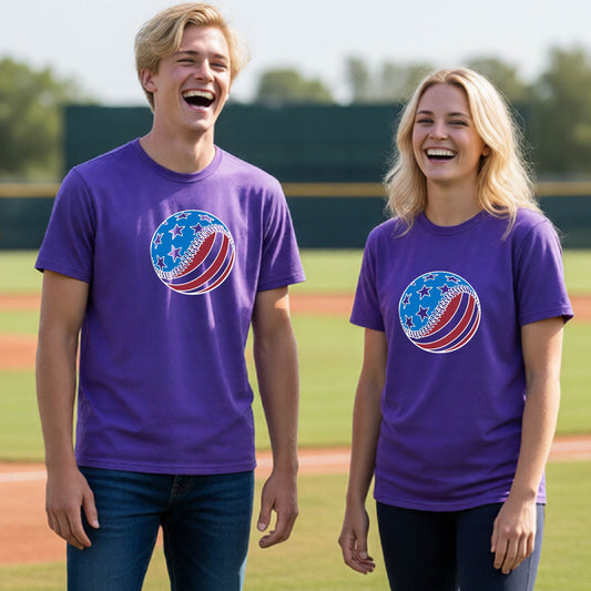 Two young athletes wearing matching purple t-shirts smiling in front of a baseball diamond  with a colored graphic of an American flag patriotic baseball with stars and stripes printed on the front of the shirts.