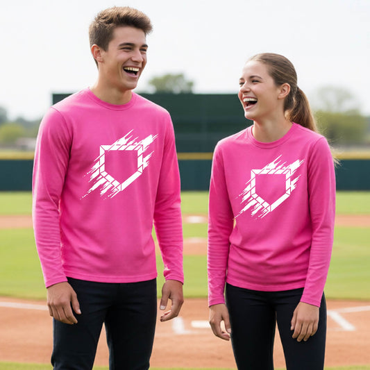 Two youth athletes wearing matching pink long-sleeve t-shirts, smiling in front of a baseball diamond, with an artistic white graphic of a sketch of baseball home plate, printed on the front of the shirt.