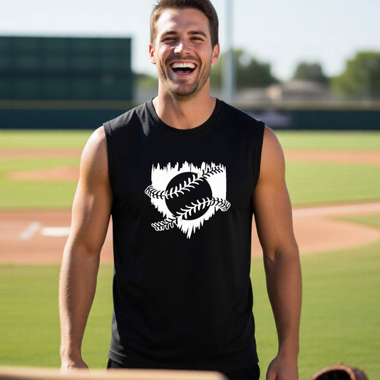A man smiling in front of a baseball diamond wearing a black sleeveless t-shirt, with an artistic white graphic of a sketch of baseball home plate with baseball stitches across the front, printed on the front of the shirt.