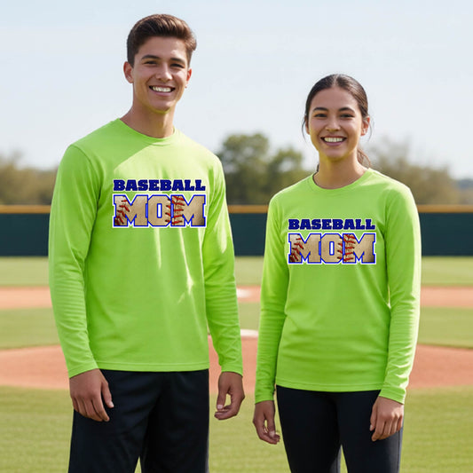 Two youth athletes wearing matching shirts, smiling in front of a baseball diamond wearing lime green long-sleeve t-shirts with a colorful graphic of the words ‘BASEBALL MOM’ printed on the front.