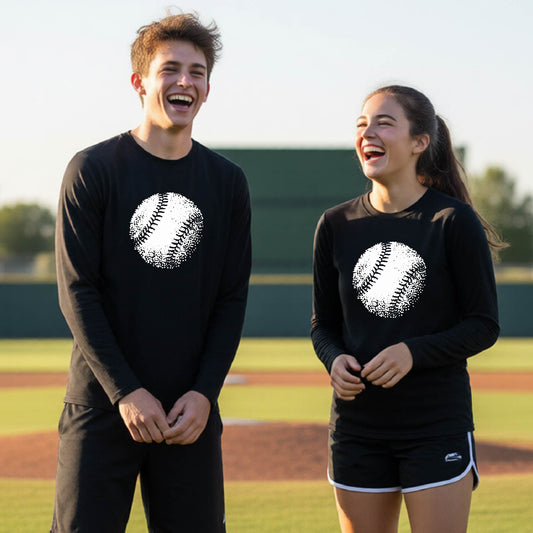 Two youth athletes wearing matching black long-sleeve t-shirts, smiling in front of a baseball diamond, with an artistic white graphic of a retro looking baseball, printed on the front of the shirt.