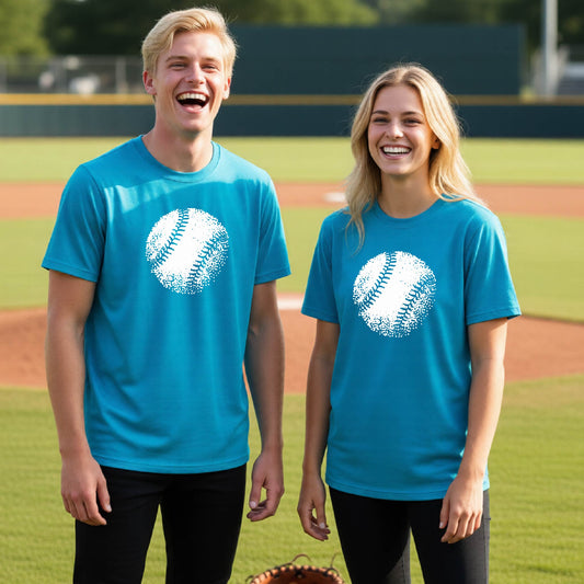 Two youth athletes wearing matching bright blue short-sleeve t-shirts, smiling in front of a baseball diamond, with an artistic white graphic of a retro looking baseball, printed on the front of the shirt.