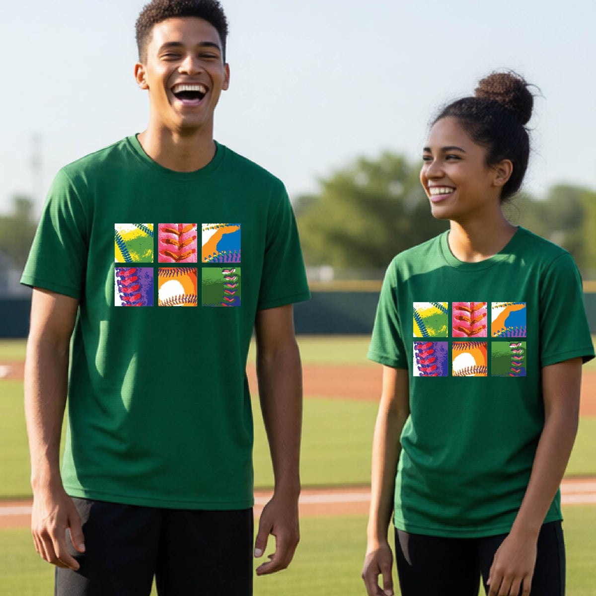 Two youth athletes wearing matching shirts, smiling in front of a baseball diamond wearing green long-sleeve t-shirts with a colorful grid graphic or 2x3 baseball squares of a baseball, printed on the front.