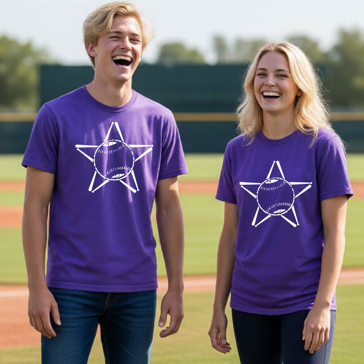 Two youth athletes wearing matching shirts, smiling in front of a baseball diamond wearing purple long-sleeve t-shirts with a white graphic of a star made of baseball bats and a ball in the middle, printed on the front.