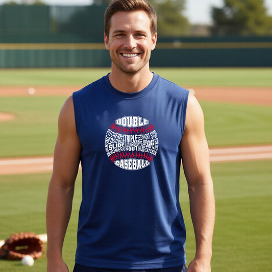 A man smiling in front of a baseball diamond wearing a royal blue sleeveless t-shirt, with a white and red graphic of a baseball made up of baseball words, printed on the front of the shirt.
