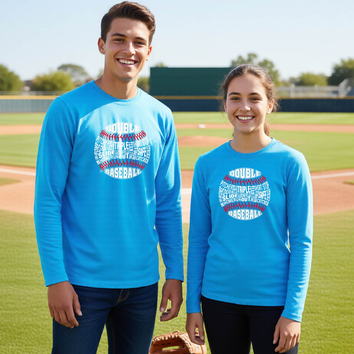 Two youth athletes wearing matching bright blue long-sleeve t-shirts, smiling in front of a baseball diamond, with a white and red graphic of a baseball made up of baseball words, printed on the front of the shirt.