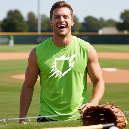 A man smiling in front of a baseball diamond wearing a lime green sleeveless t-shirt, with an artistic white graphic of a sketch of baseball home plate, printed on the front of the shirt.