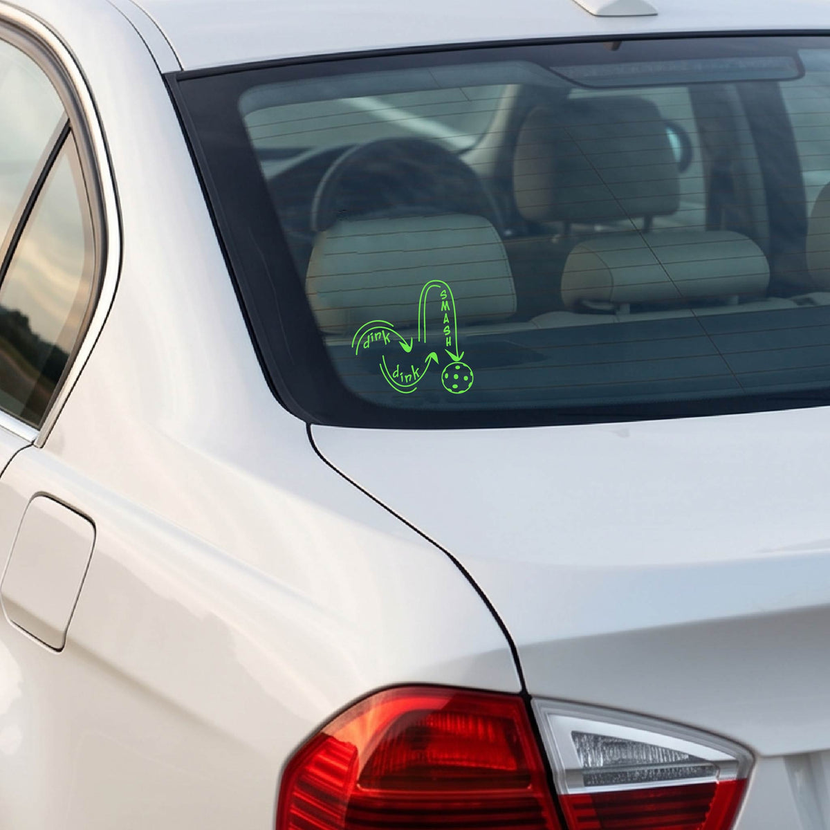 A green vinyl decal of a pickelball logo' DINK DINK SMASH' an a yellow pickleball, applied a vehicle window. 