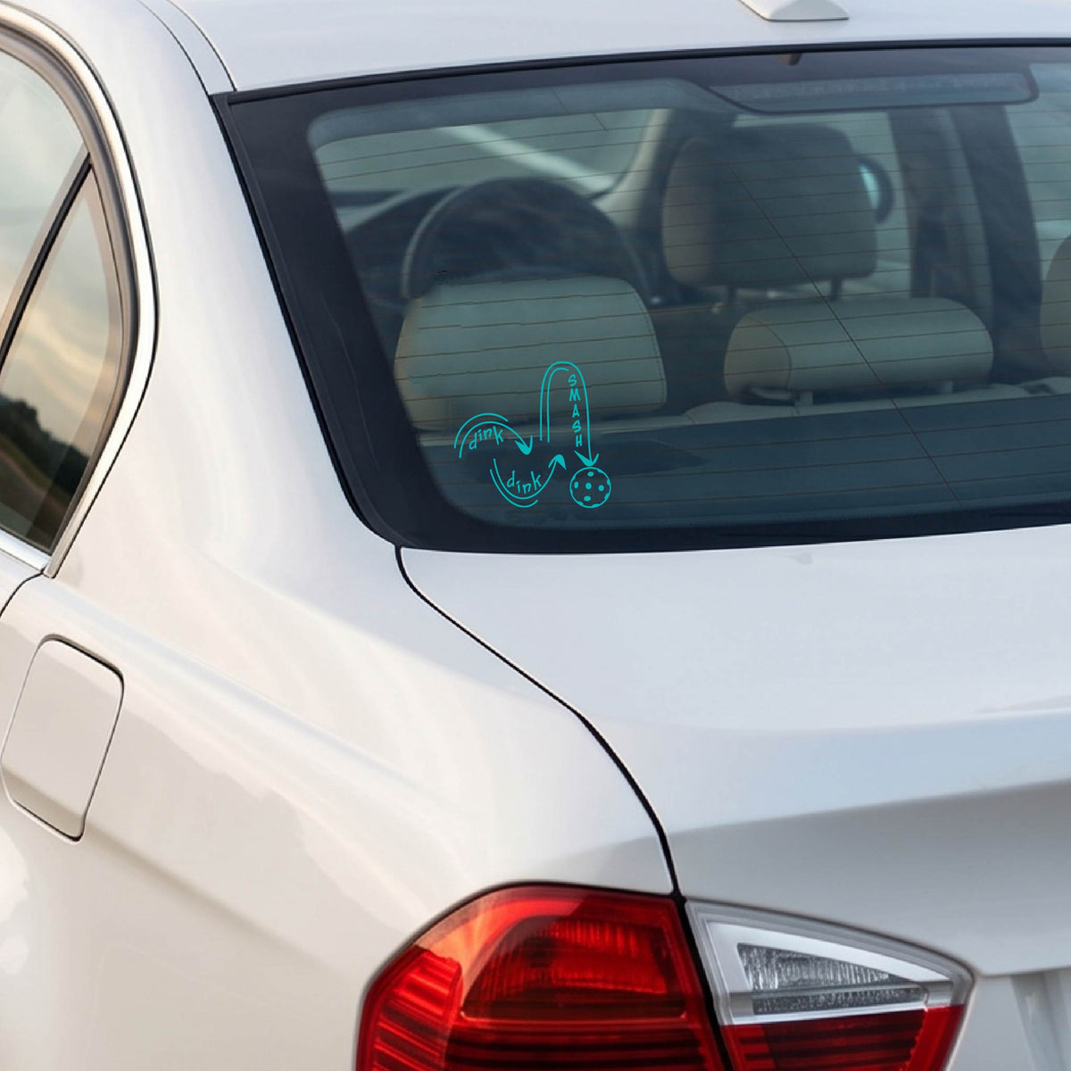 A turquoise vinyl decal of a pickelball logo' DINK DINK SMASH' an a yellow pickleball, applied a vehicle window. 