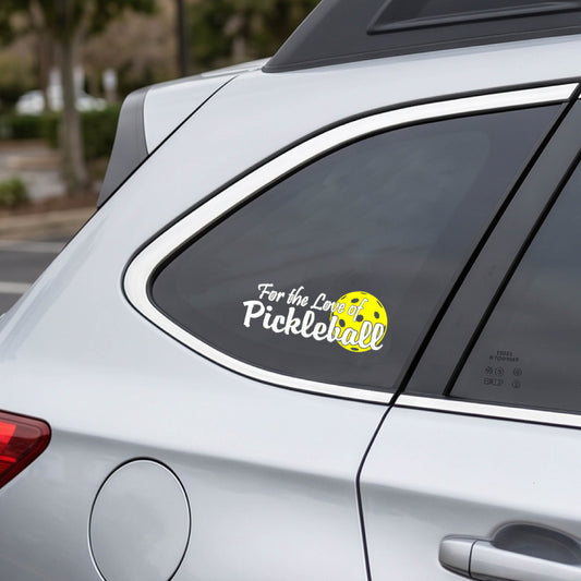 A close-up of a car decal and a pickleball graphic of ‘FOR THE LOVE OF PICKLEBALL’ in white with a yellow pickleball behind it graphic on the front.