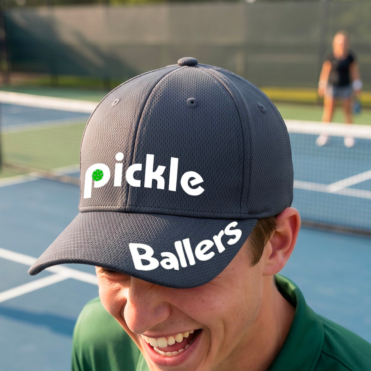 A close up of a graphite gray mid-profile pickleball baseball cap with the text 'pickle' across the front and 'ballers' curved on the brim. 