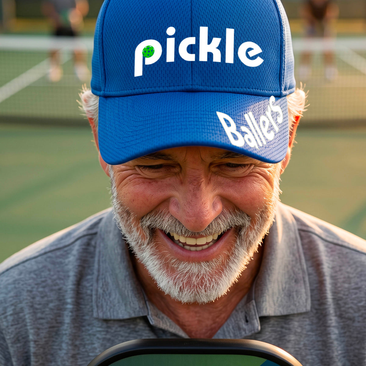 A close up of a royal blue mid-profile pickleball baseball cap with the text 'pickle' across the front and 'ballers' curved on the brim. 