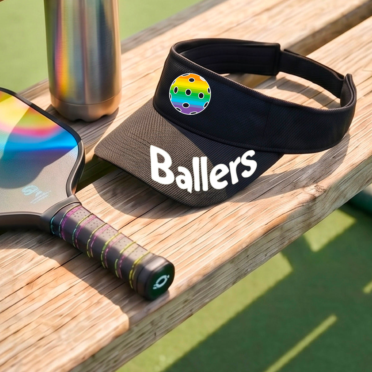 A close up of a black visor with pickleball graphic and the word 'Ballers' in white,.