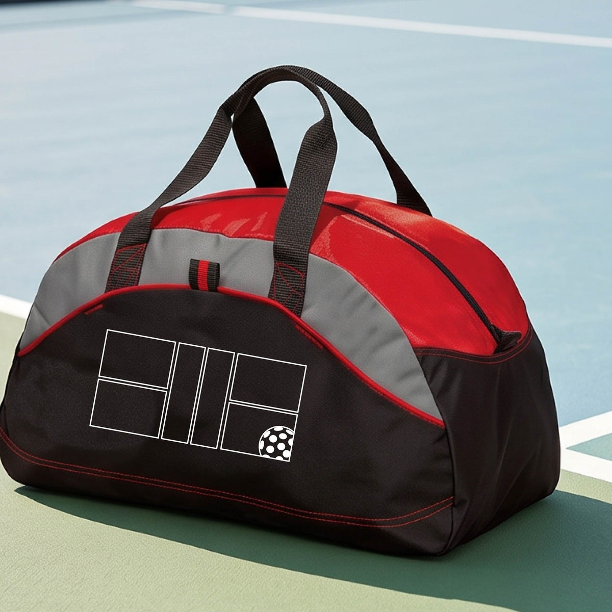 A close up of red, gray and black pickleball duffel bag with a white pickleball court and ball graphic.
