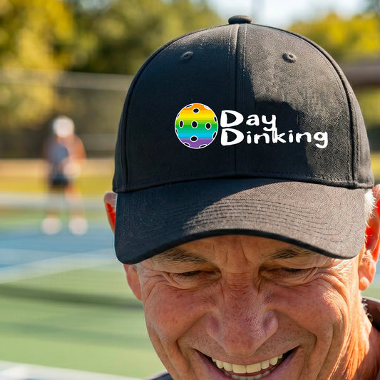 A close up of a black mid-profile hat  with a white 'Day Dinking' graphic with a colorful pickleball icon