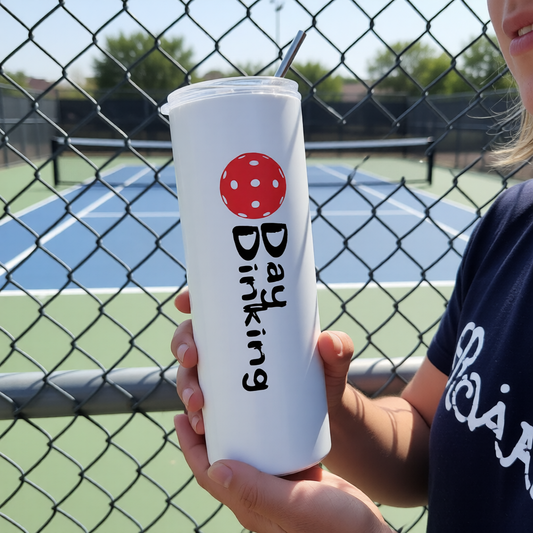 A white stainless steel tumbler with a fun pickleball graphic of a red Pickleball and the text 'DAY DINKING"