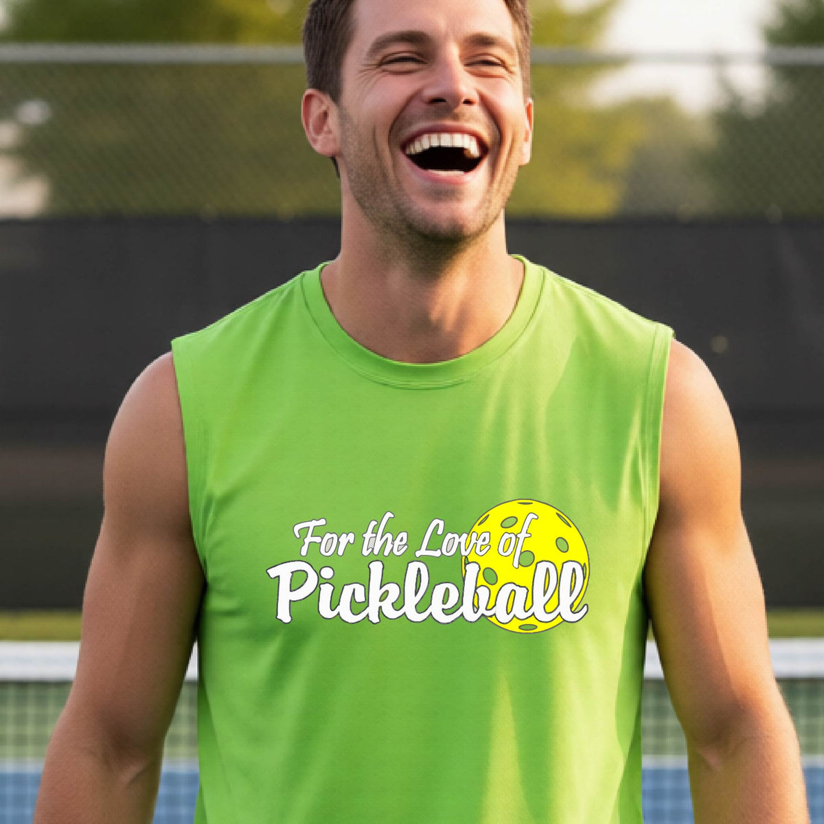 A close-up of a man wearing a lime green sleeveless t-shirt with a pickleball graphic on the left bottom left of ‘FOR THE LOVE OF PICKLEBALL’ in white with a yellow pickleball behind it.  