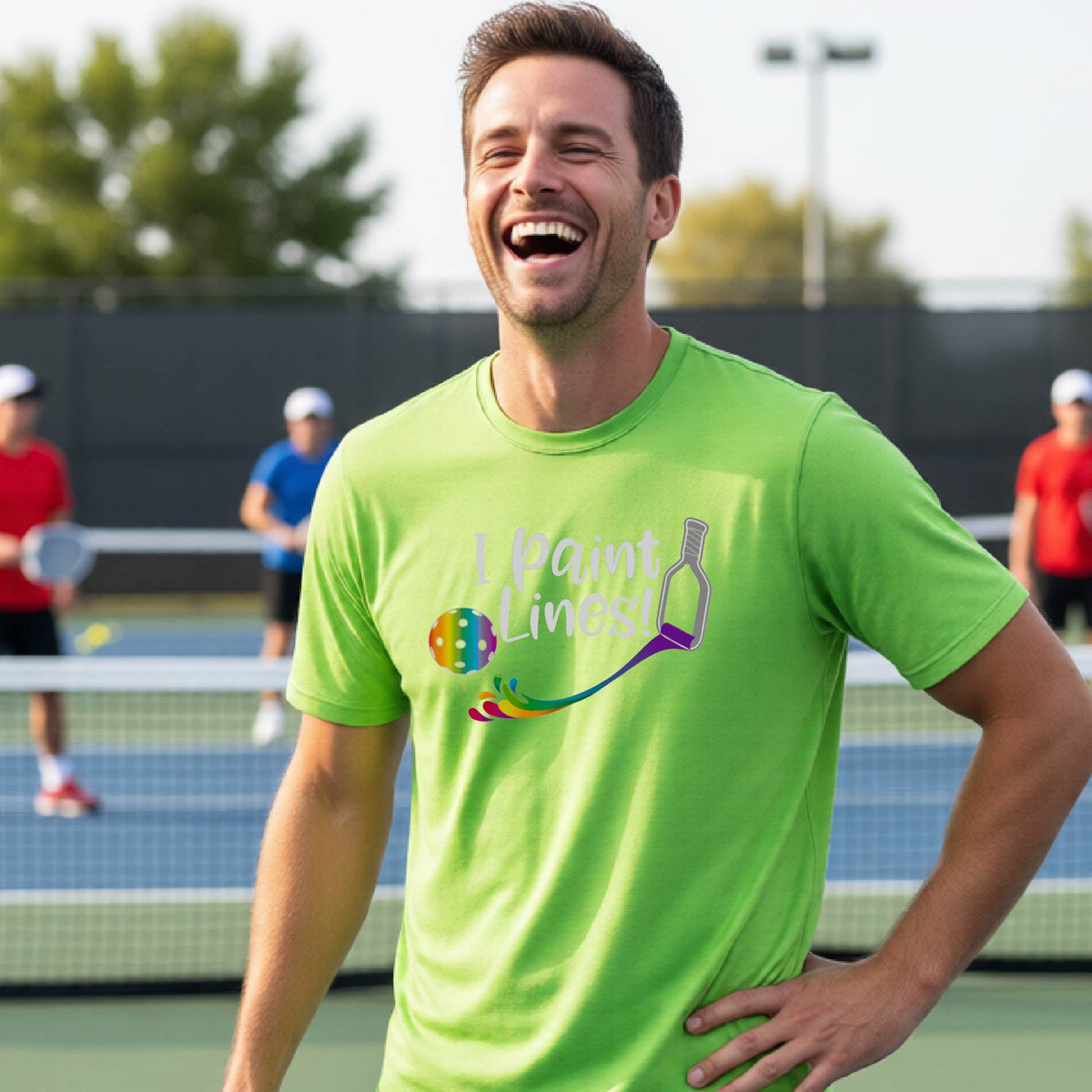 A close-up of a woman wearing a lime green short-sleeve t-shirt with a graphic on the front that has white text "I PAINT LINES'  with a white pickleball paddle painting multi-colored lines leading a mutli-colored pickleball.