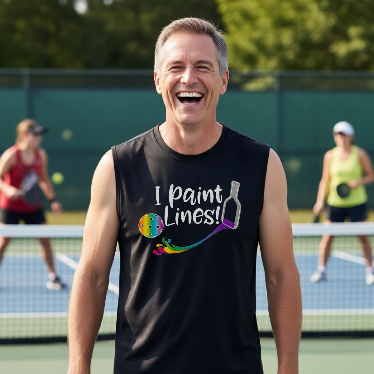 A close-up of a man wearing a coral lime black sleeveless t-shirt with a graphic on the front that has white text "I PAINT LINES'  with a white pickleball paddle painting multi-colored lines leading a mutli-colored pickleball.