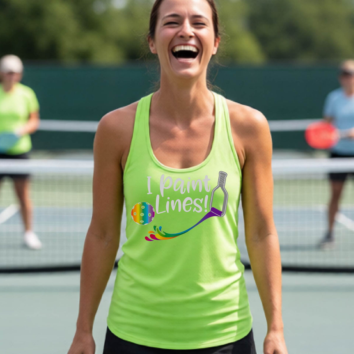 A close-up of a woman wearing a lime green racerback tank top with a graphic on the front that has white text "I PAINT LINES'  with a white pickleball paddle painting multi-colored lines leading a mutli-colored pickleball.