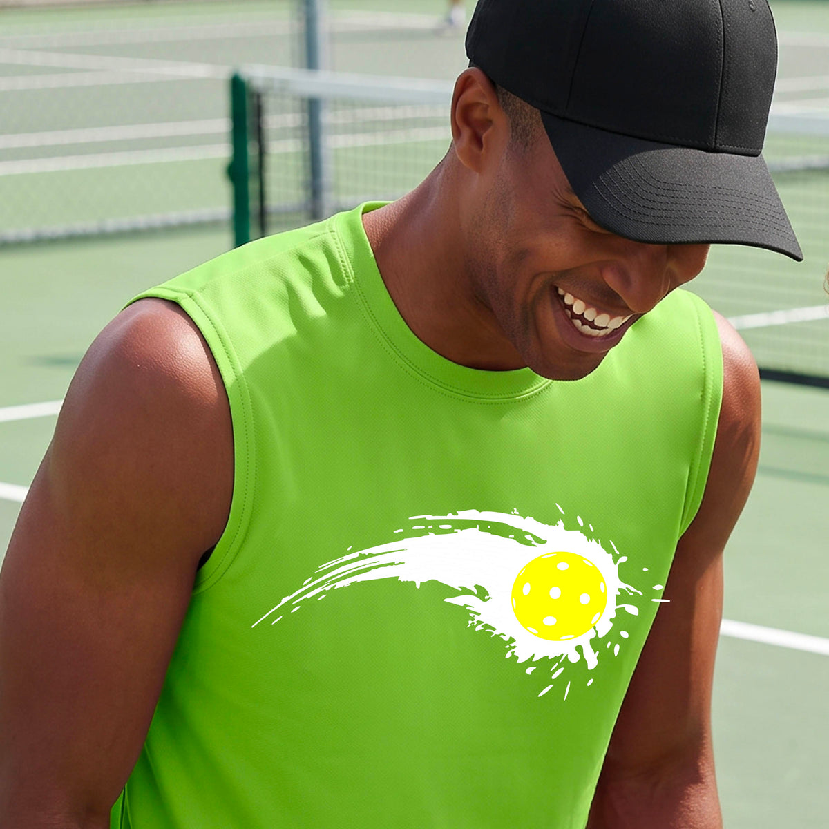 A man wearing a lime green sleeveless T-shirt with a white pickleball graphic of a yellow pickleball with a motion trail effect, displayed in front of a pickleball court. 