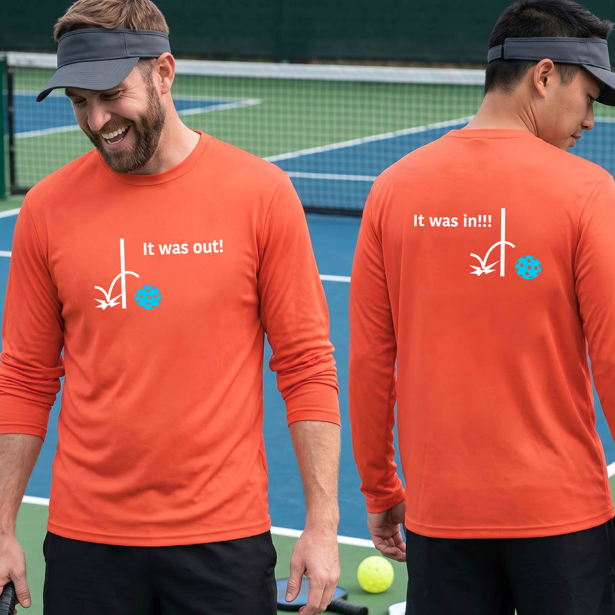 Two men showing an orange long-sleeve t-shirt with a white design of ‘IT WAS OUT!’ and a colorful pickleball on the front, and the back design with a white ‘IT WAS IN!!!’ and a colorful pickleball, standing on a pickleball court.