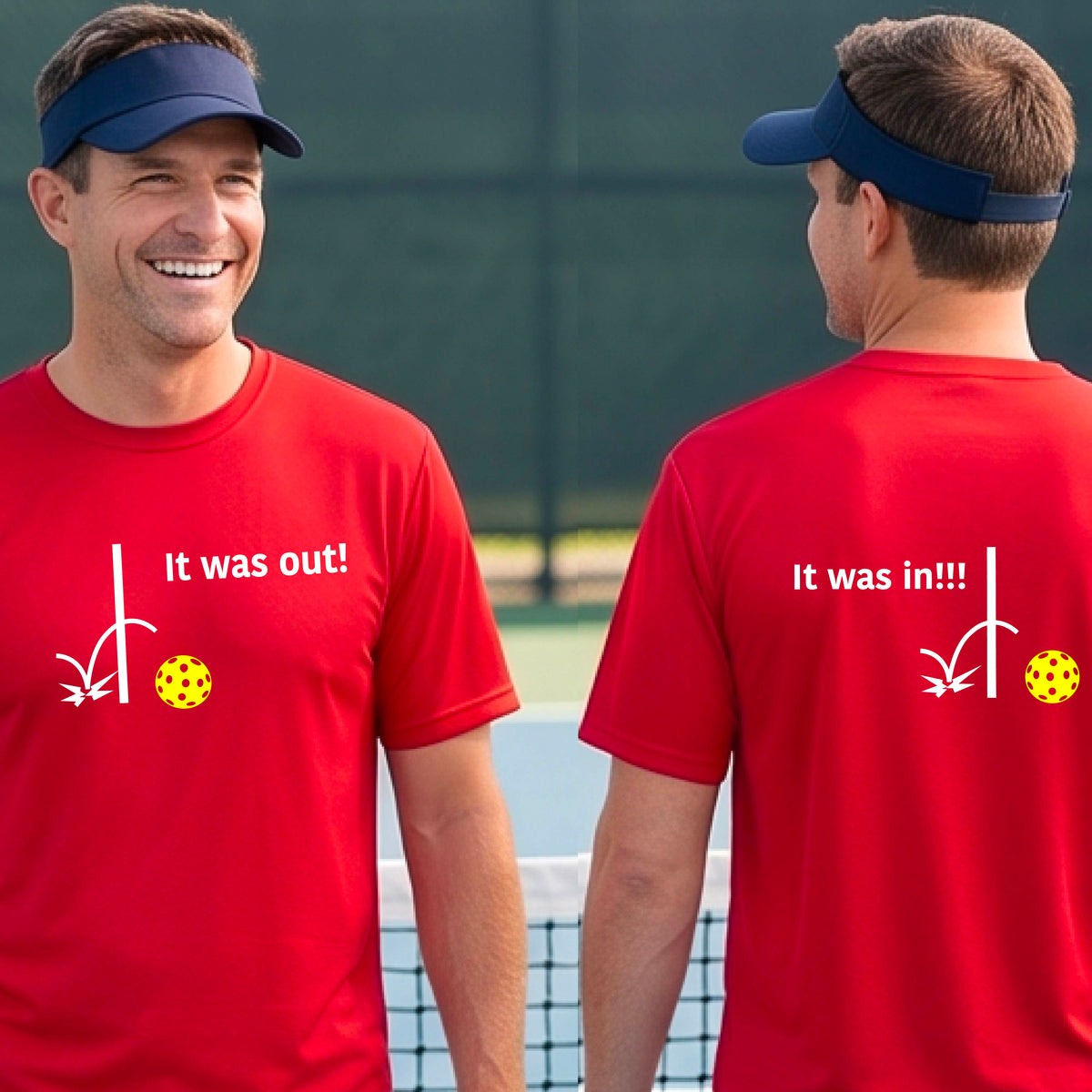 Two men showing a red short-sleeve t-shirt with a white design of ‘IT WAS OUT!’ and a colorful pickleball on the front, and the back design with a white ‘IT WAS IN!!!’ and a colorful pickleball, standing on a pickleball court. 