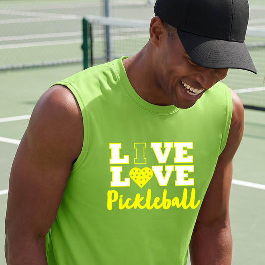 A man on a pickleball court wearing a lime green sleeveless V-neck shirt with a yellow graphic that reads 'LIVE LOVE Pickleball' and a heart-shaped pickleball dot pattern inside the word 'LOVE'.