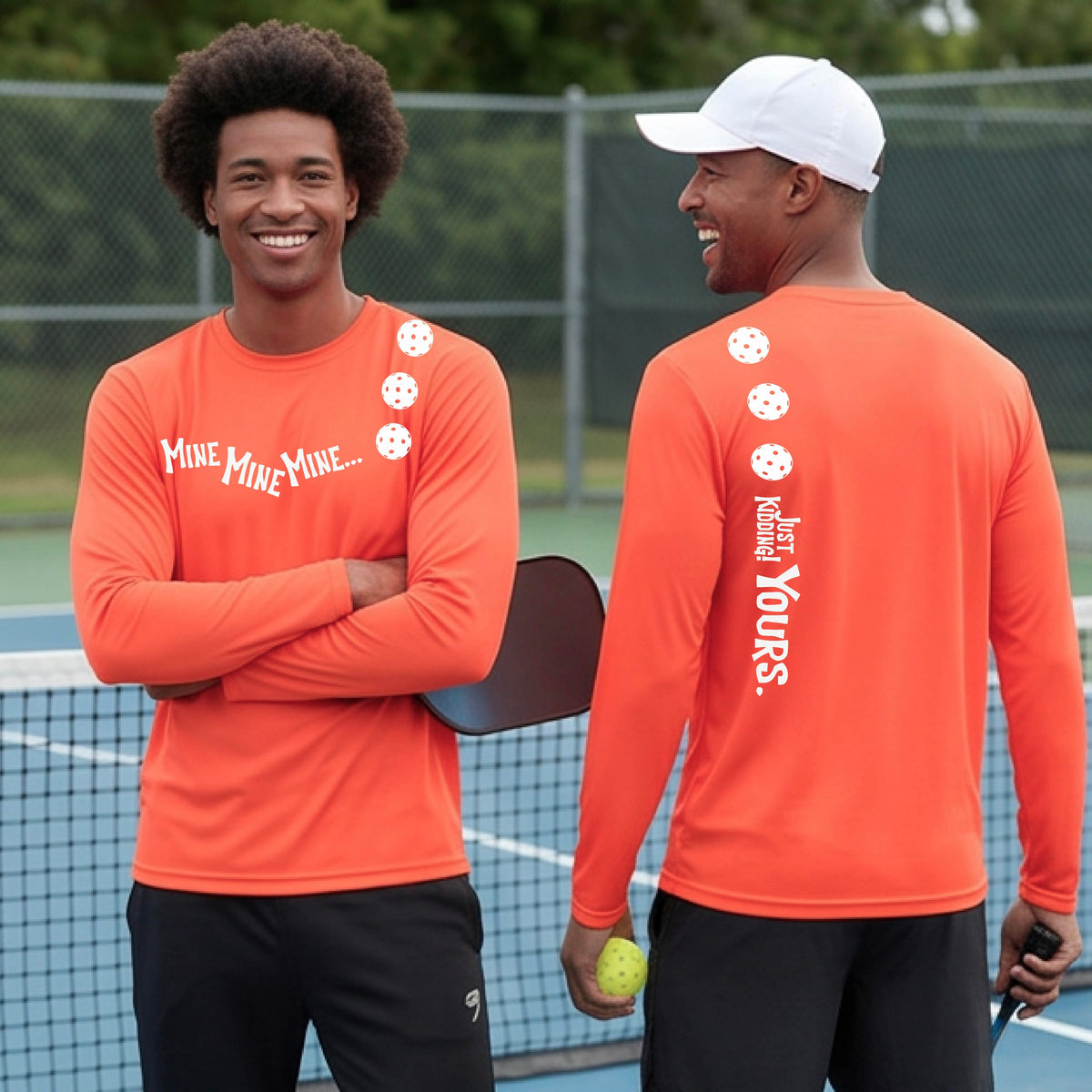Two men on a pickleball court wearing matching orange long-sleeve t-shirts. One shows the front with the text 'MINE MINE MINE' along with three pickleball graphics. and the back text 'JUST KIDDING YOURS, along with three pickleball graphics.