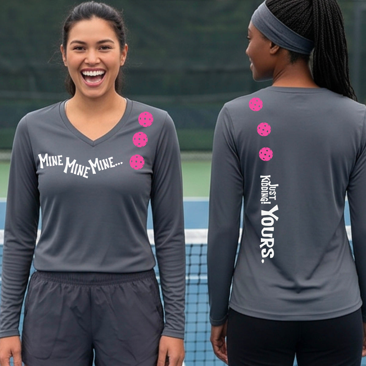 Two women on a pickleball court wearing matching dark gray long-sleeve athletic t-shirts. One shows the front with the text 'MINE MINE MINE' along with three pickleball graphics. and the back text 'JUST KIDDING YOURS, along with three pickleball graphics.