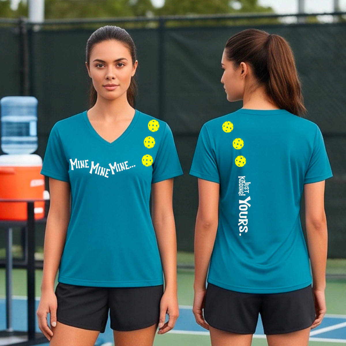 Two women on a pickleball court wearing matching tropic blue short-sleeve v-neck t-shirts.  One shows the front with the text 'MINE MINE MINE' along with three pickleball graphics. and the back text 'JUST KIDDING YOURS, along with three pickleball graphics.