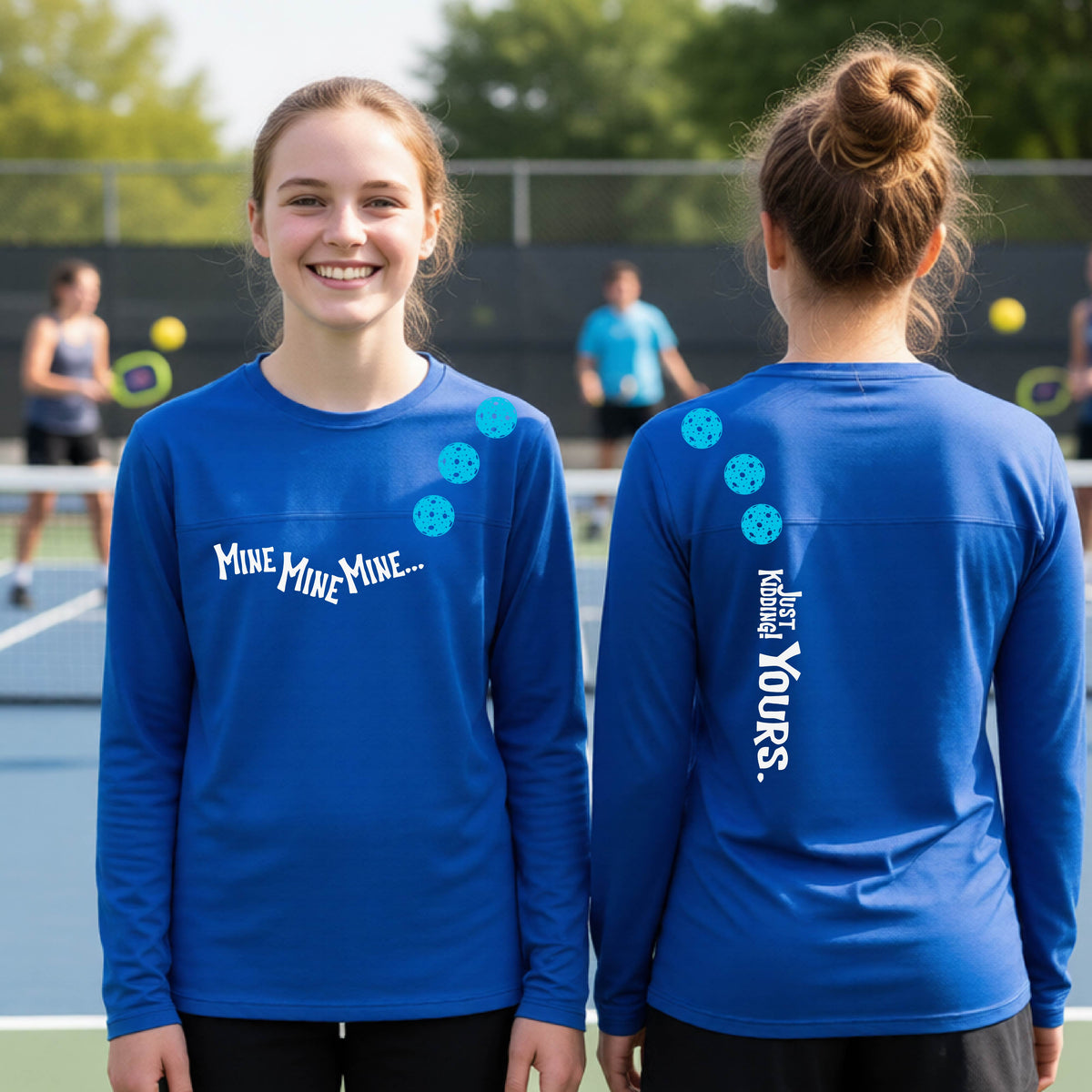 Two teenagers on a pickleball court wearing matching royal blue athletic tank tops  One shows the front with the text 'MINE MINE MINE' along with three pickleball graphics. and the back text 'JUST KIDDING YOURS, along with three pickleball graphics.