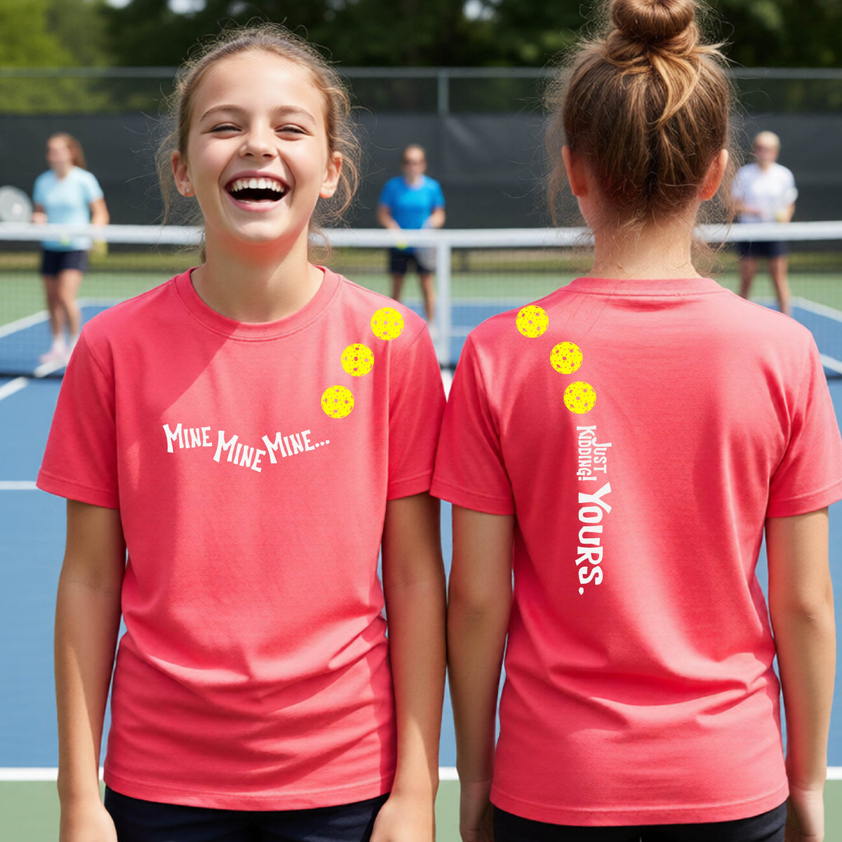 Two teenagers on a pickleball court wearing matching coral pink athletic tank tops  One shows the front with the text 'MINE MINE MINE' along with three pickleball graphics. and the back text 'JUST KIDDING YOURS, along with three pickleball graphics.