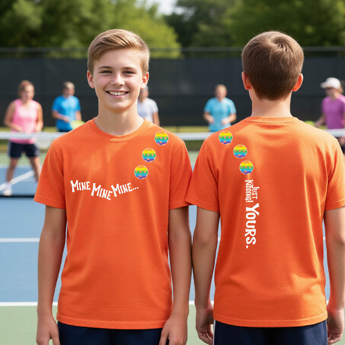 Two teenagers on a pickleball court wearing matching bright orange athletic tank tops  One shows the front with the text 'MINE MINE MINE' along with three pickleball graphics. and the back text 'JUST KIDDING YOURS, along with three pickleball graphics.