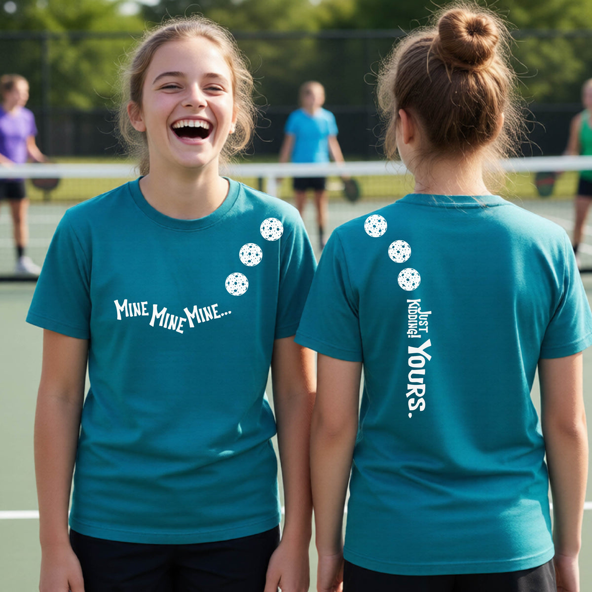 Two teenagers on a pickleball court wearing matching tropic blue athletic tank tops  One shows the front with the text 'MINE MINE MINE' along with three pickleball graphics. and the back text 'JUST KIDDING YOURS, along with three pickleball graphics.