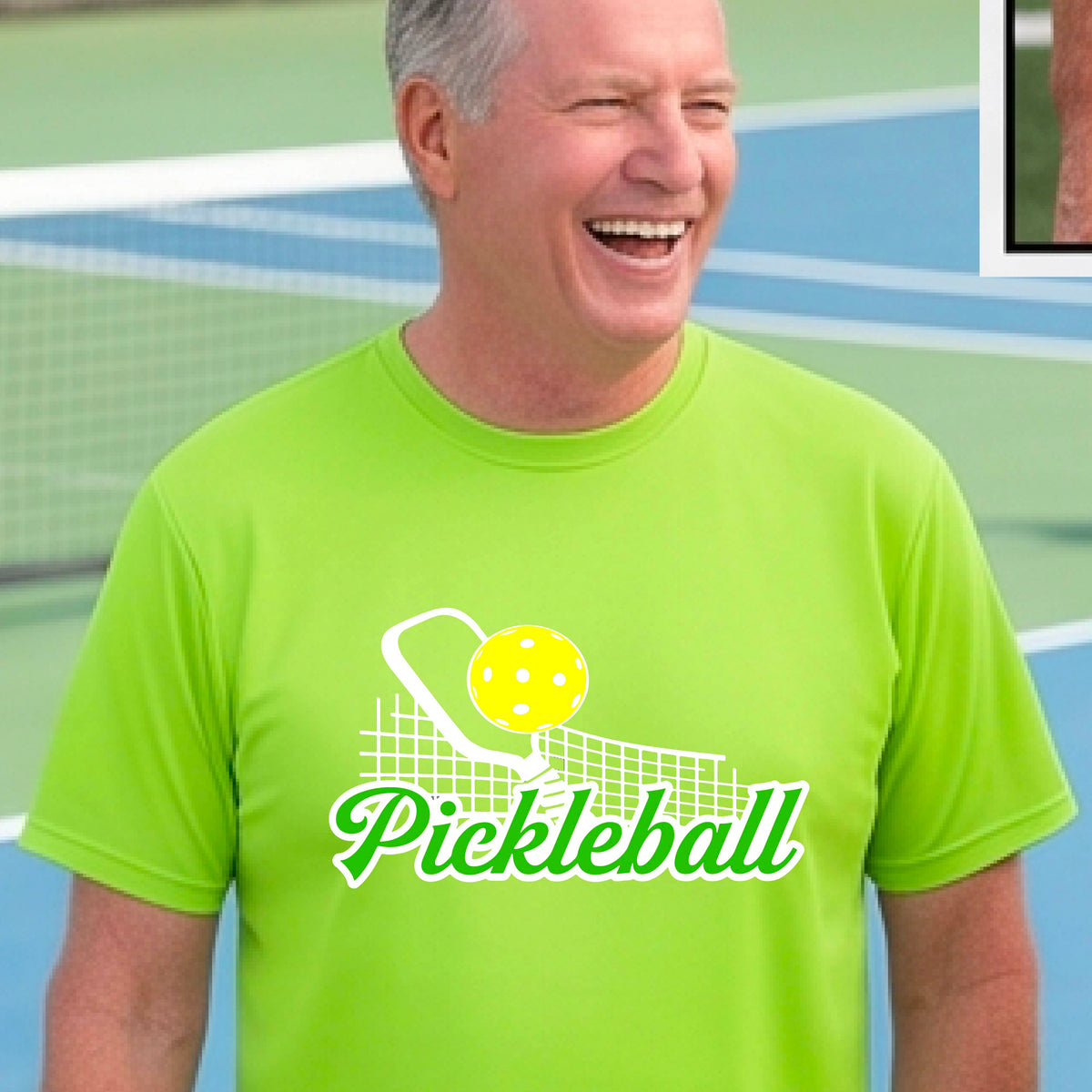 A man wearing a lime green short-sleeve t-shirt with a graphic on the front that has white and green text "PICKLEBALL'  with a white pickleball paddle and net and a yellow pickleball above the text graphic.