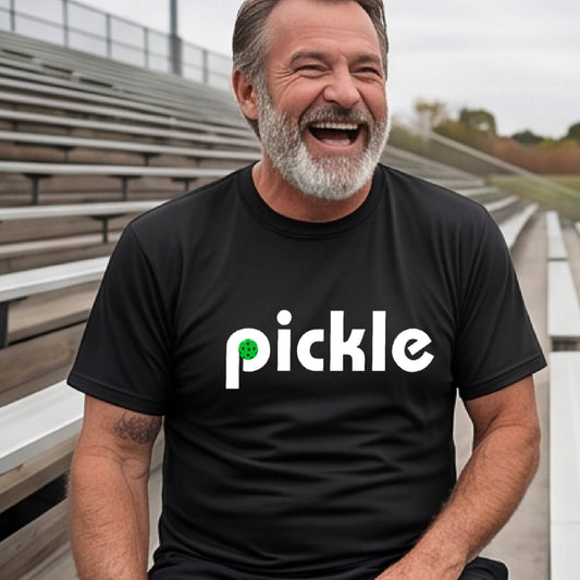 A man wearing a black long-sleeve t-shirt with a white graphic of ‘PICKLE’ with a green pickleball integrated into the letter P printed on the front.