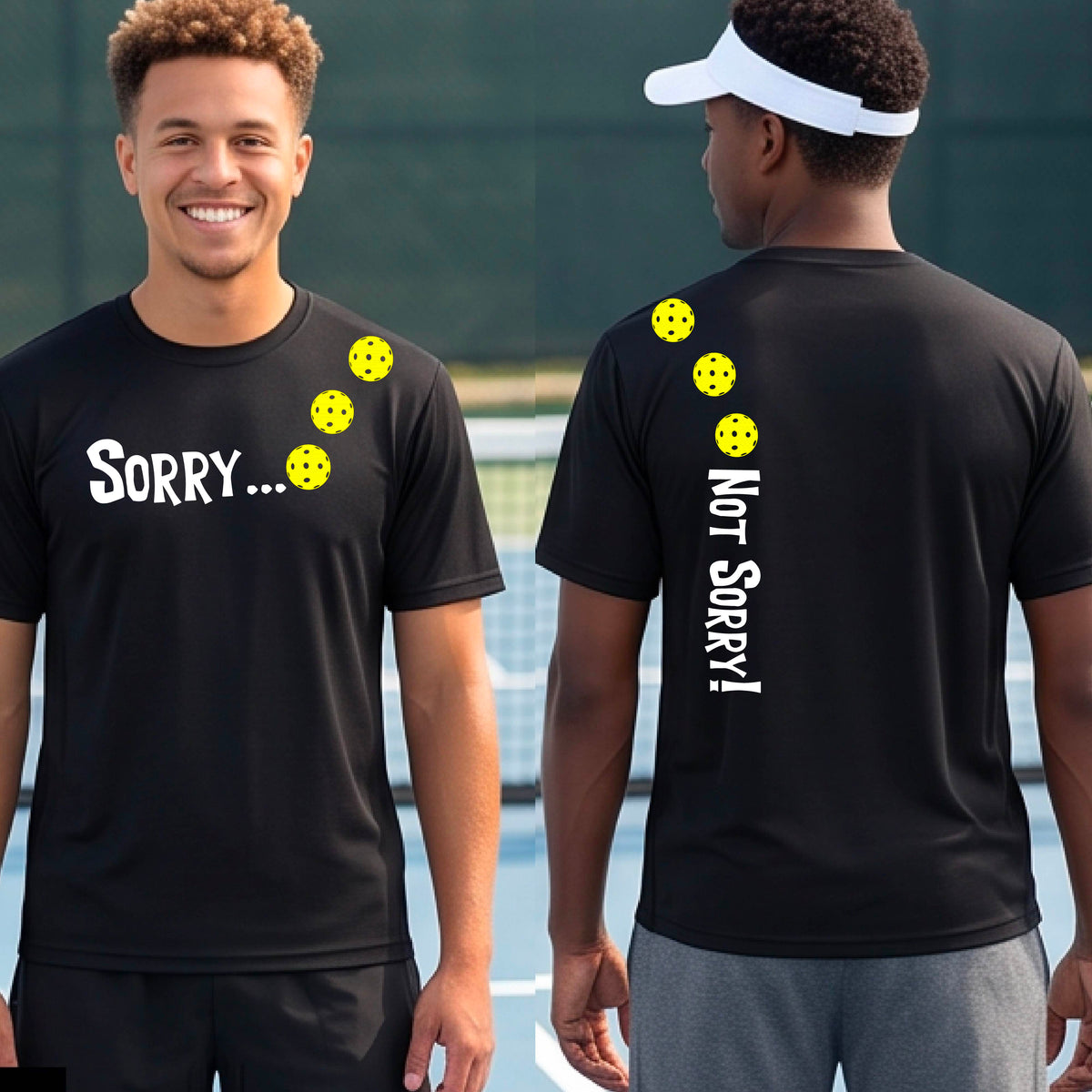 Two men on a pickleball court wearing black short-sleeve t-shirts with a front/back graphic design.  The front features the playful word “SORRY…” in bold white lettering, accented with three colorful pickleballs arranged diagonally across the upper chest.  The back design features “NOT SORRY!” in bold white lettering running vertically down the upper back, with three matching colorful pickleballs positioned above lettering. 