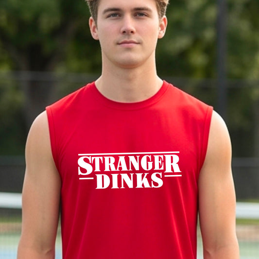 A man on a pickleball court wearing a red short-sleeve t-shirt with a white graphic of the words “STRANGER DINKS” on the front of the shirt in the style of the popular TV Series Stranger Things. 