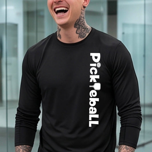 A man wearing a black long-sleeve athletic shirt with 'Pickleball' printed vertically in white on the right side of the chest, set against a blurred modern glass office background.