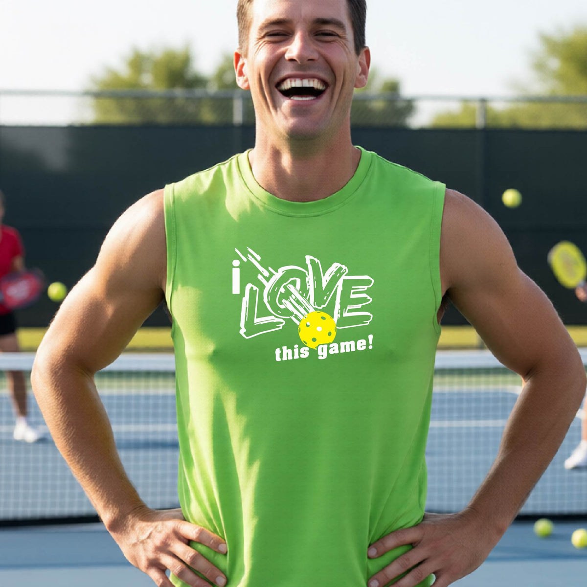 A smiling man on a pickleball court wearing a bright lime green sleeveless tank top with a white graphic that reads 'i LOVE this game!' and a yellow pickleball detail.