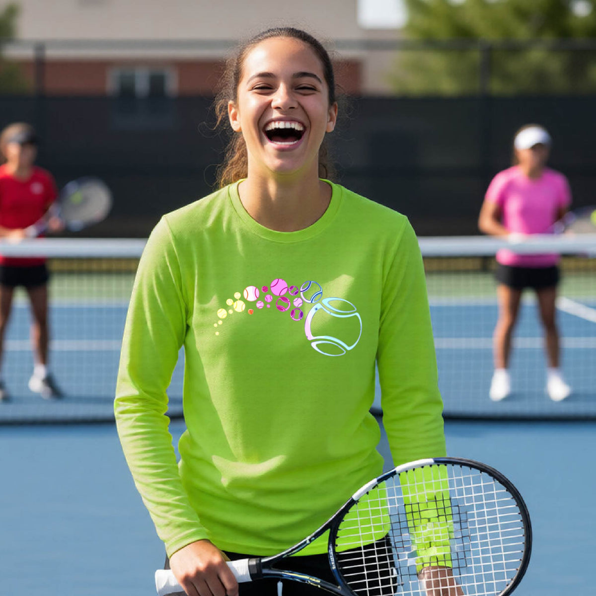 A young person on a tennis court wearing a lime green long-sleeve t-shirt with a graphic of pastel gradient colored tennis balls arcing in flight and gradually getting larger.