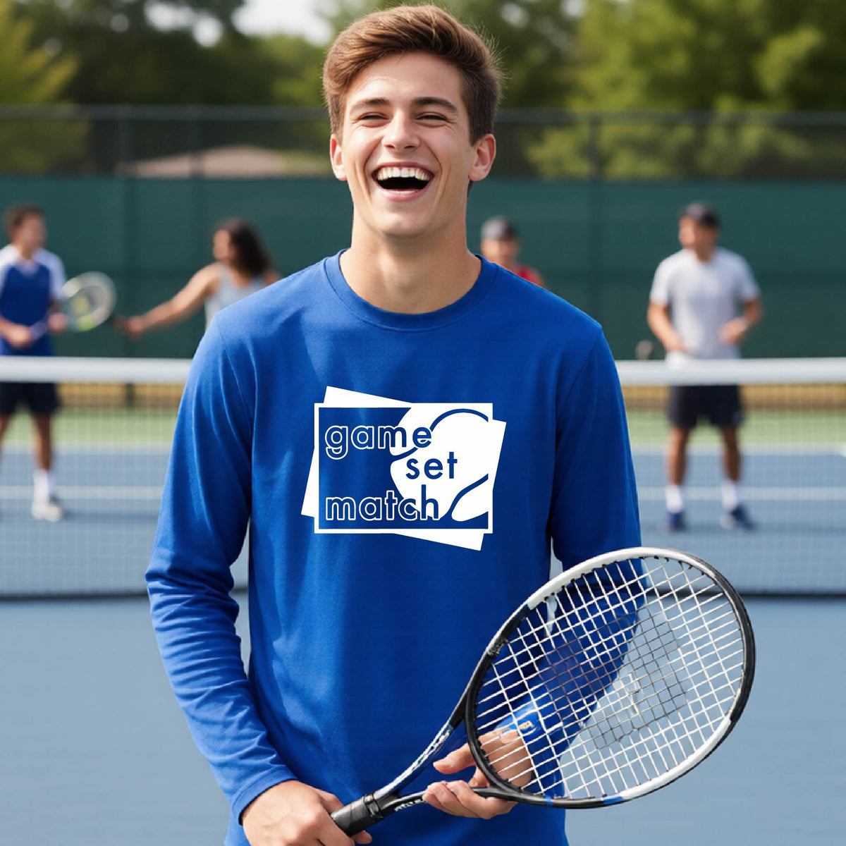 A young person on a blue tennis court holds a tennis racket and wears a royal blue long-sleeve T-shirt with a white graphic of two overlapping white and gray squares with the cut out words of ‘GAME SET MATCH” and a tennis ball, printed on the front of the shirt. 