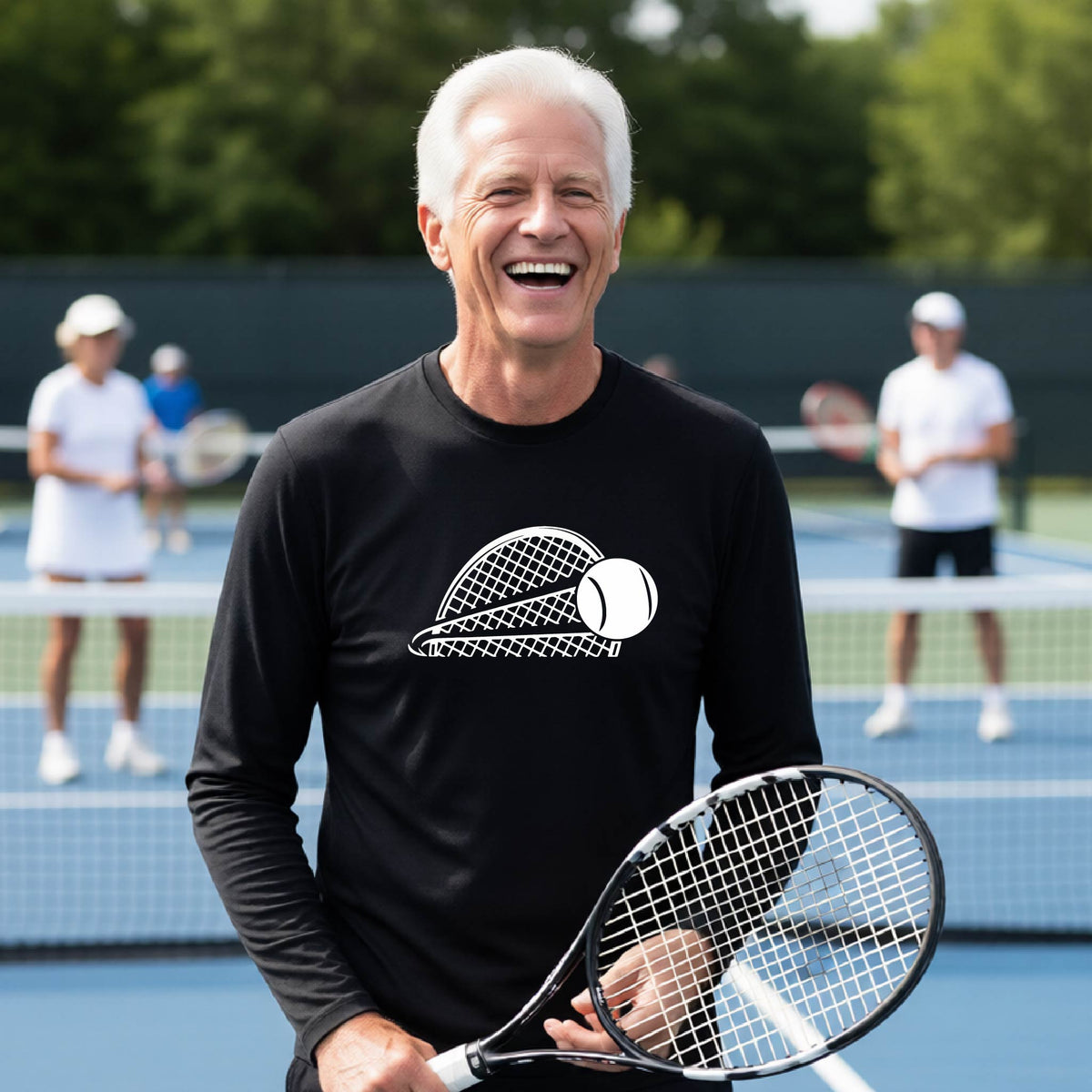 A man on a blue tennis court holds a tennis racket and wears a black long-sleeve T-shirt with a white graphic of a half a tennis racquet with a ball streaking over it. 