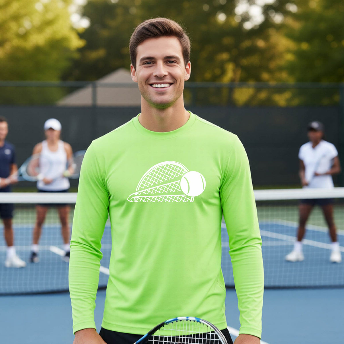 A man on a blue tennis court holds a tennis racket and wears a lime green long-sleeve T-shirt with a white graphic of a half a tennis racquet with a ball streaking over it. 